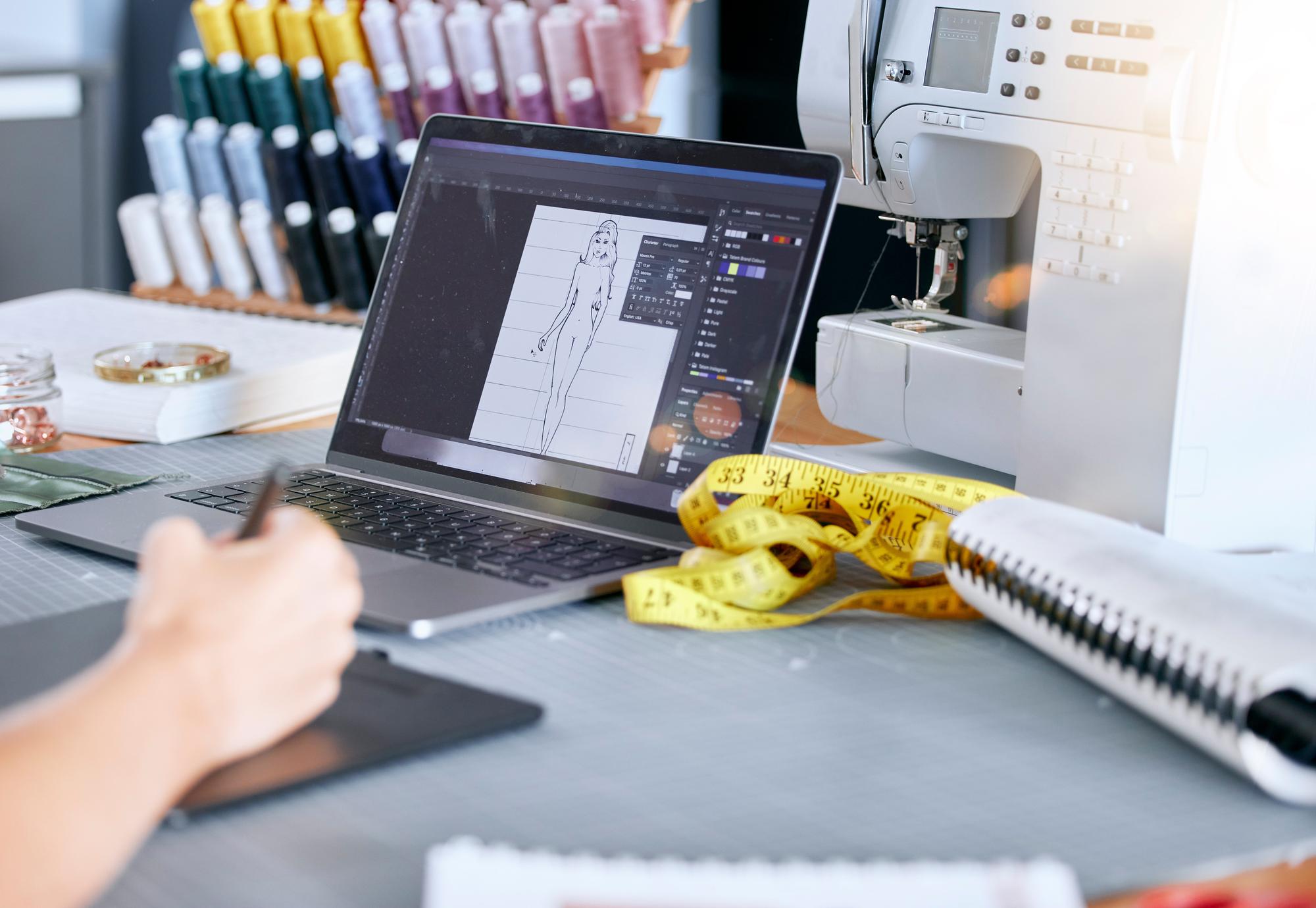 Studio workspace with embroidery machine and monitor